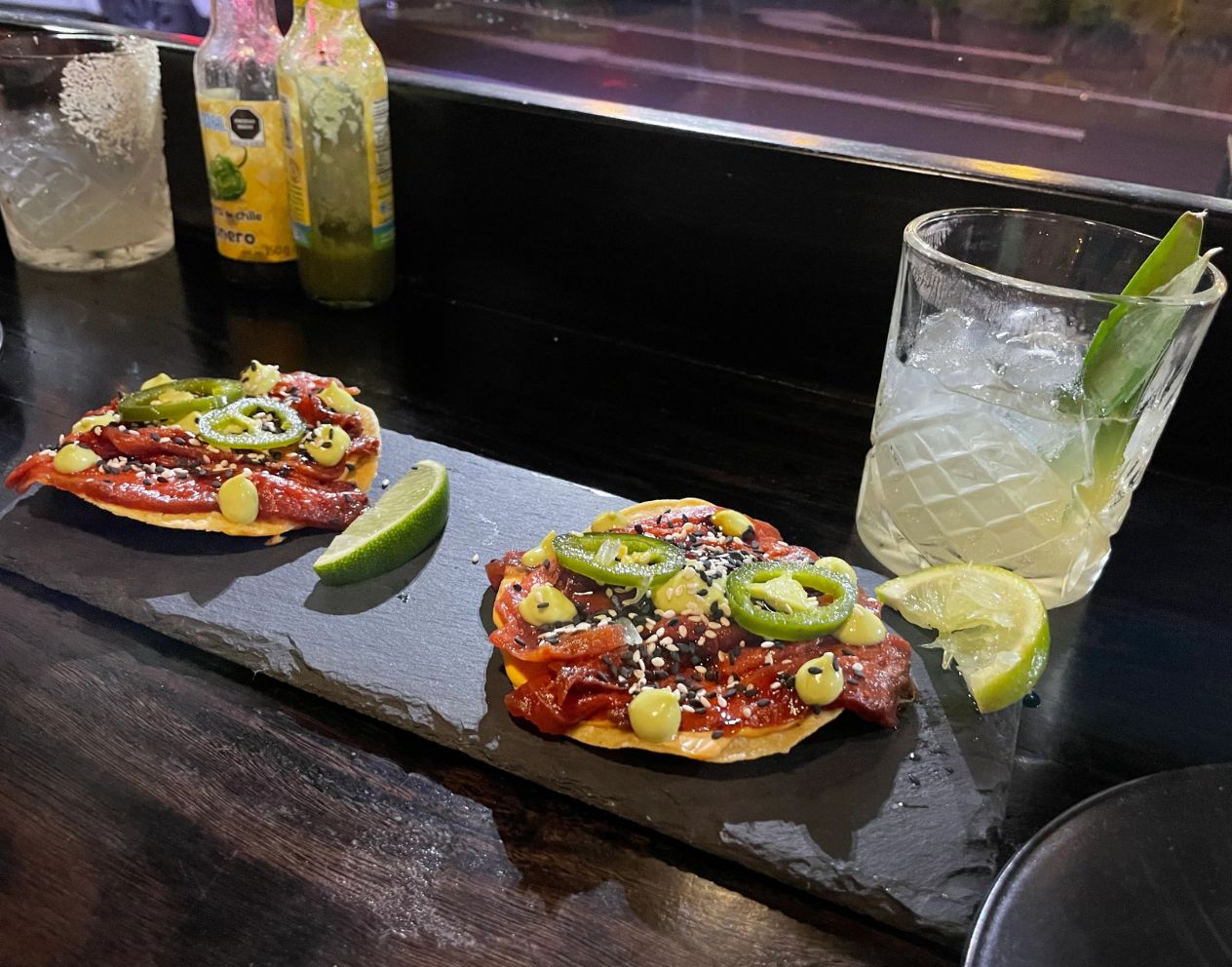 watermelon tostada and cocktail on table